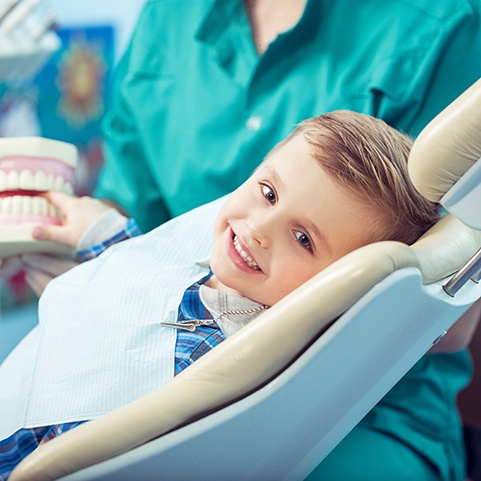 Happy little boy smiling in treatment chair