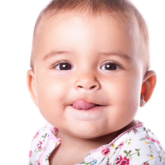 Infant girl sticking her tongue out