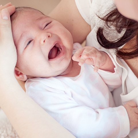 Mother holding fussy infant