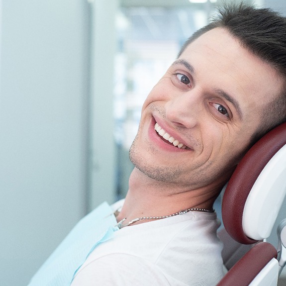Close-up of smiling man in a dental chair