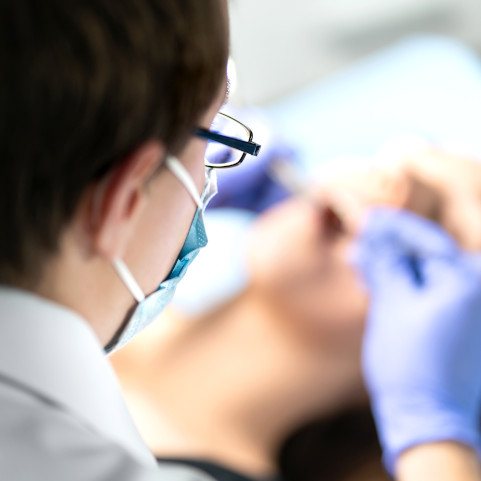 Closeup of dentist working on patient's teeth